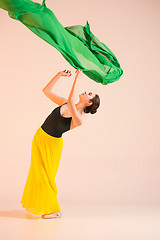 Image showing Young and incredibly beautiful ballerina is dancing at studio