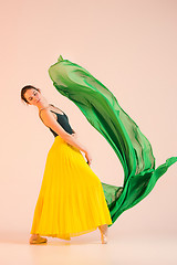 Image showing Young and incredibly beautiful ballerina is dancing at studio