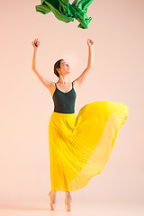 Image showing Young and incredibly beautiful ballerina is dancing at studio