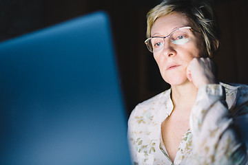 Image showing Middle-aged woman working on laptop