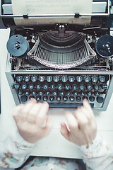 Image showing Writer typing with retro writing machine.