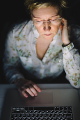 Image showing Middle-aged woman working on laptop