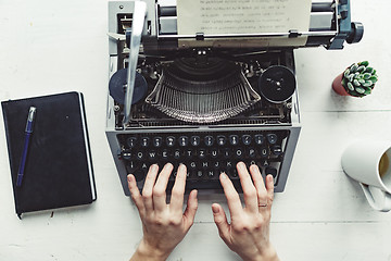 Image showing Writer typing with retro writing machine.