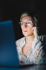 Image showing Middle-aged woman working on laptop