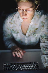 Image showing Middle-aged woman working on laptop