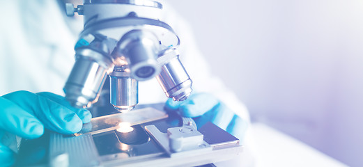 Image showing Close up of examining of test sample under the microscope