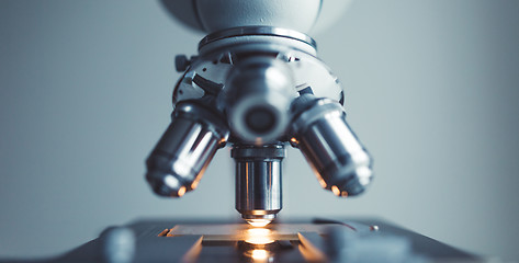 Image showing Close up of examining of test sample under the microscope