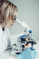 Image showing Close up of examining of test sample under the microscope