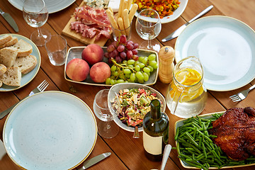 Image showing various food on served wooden table