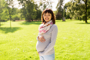 Image showing happy pregnant asian woman at park