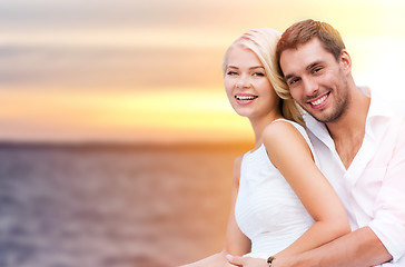 Image showing happy couple hugging over sea background