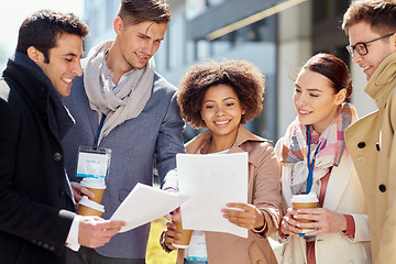 Image showing international business team with papers outdoors