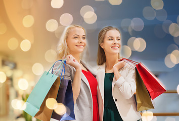 Image showing happy young women with shopping bags in mall