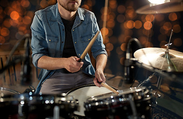 Image showing male musician playing drum kit at concert