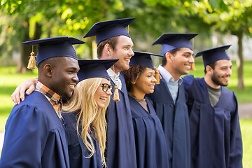 Image showing happy students or bachelors in mortar boards