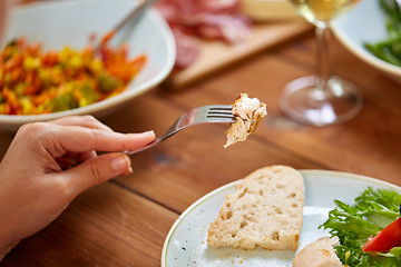 Image showing hand with chicken meat on fork