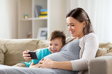 Image showing pregnant mother and son with smartphone at home