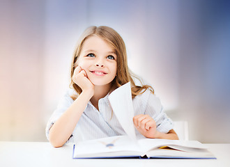 Image showing happy smiling student girl reading book