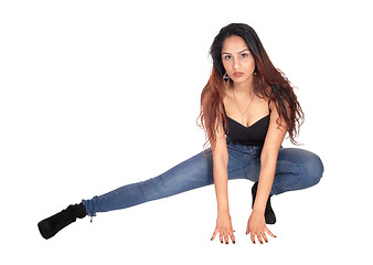 Image showing Slim woman crouching on the floor