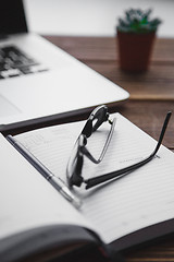 Image showing Working place with laptop on wooden table