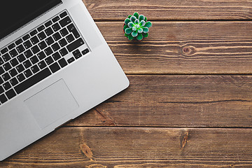 Image showing Working place with laptop on wooden table