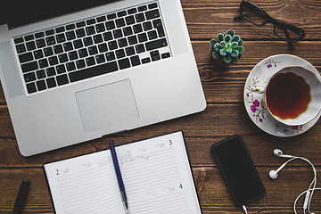 Image showing Working place with laptop on wooden table