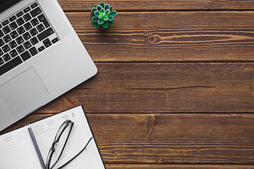 Image showing Working place with laptop on wooden table