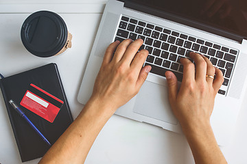 Image showing Man working on laptop placed on white desk