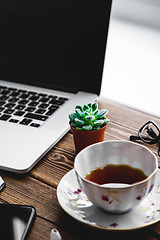 Image showing Working place with laptop on wooden table