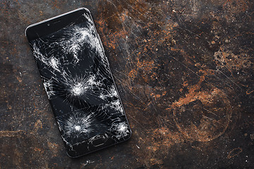 Image showing Big modern smartphone with broken screen debris