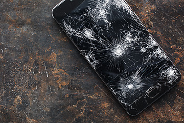 Image showing Big modern smartphone with broken screen debris