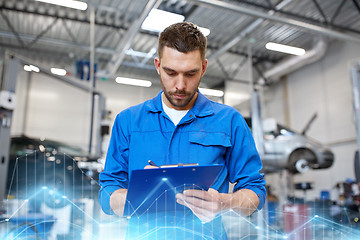 Image showing auto mechanic man with clipboard at car workshop