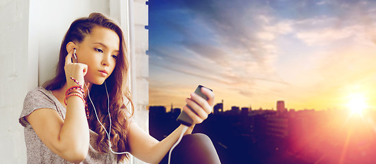 Image showing teenage girl with smartphone and earphones