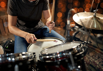 Image showing male musician playing drum kit at concert