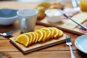 Image showing sliced orange and other food on wooden table