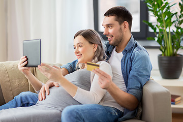 Image showing man and pregnant wife shopping online at home