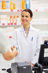 Image showing apothecary taking credit card at pharmacy cashbox