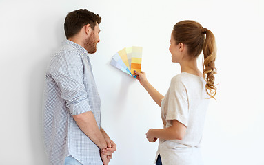 Image showing happy couple with color samples at new home