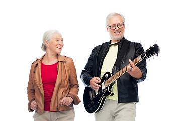 Image showing happy senior couple with electric guitar