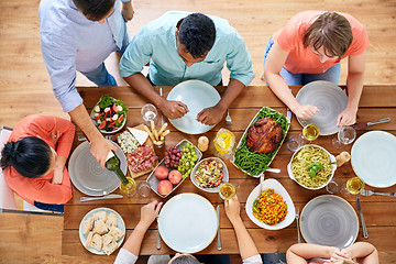 Image showing group of people eating at table with food