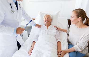 Image showing senior woman and doctor with clipboard at hospital