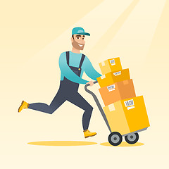 Image showing Delivery postman with cardboard boxes on trolley.