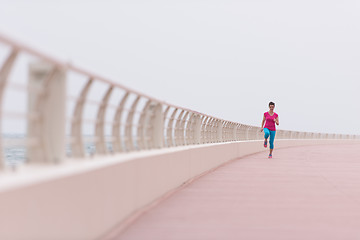 Image showing woman busy running on the promenade