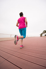 Image showing woman busy running on the promenade