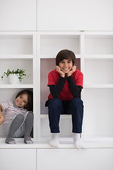 Image showing young boys posing on a shelf