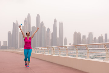 Image showing young woman celebrating a successful training run