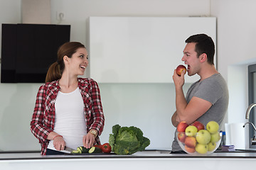 Image showing Young handsome couple in the kitchen