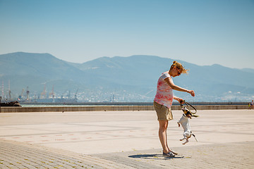 Image showing Woman with her dog playing