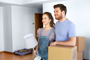 Image showing couple with boxes and lamp moving to new home