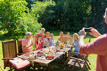 Image showing happy family photographing by smartphone in summer